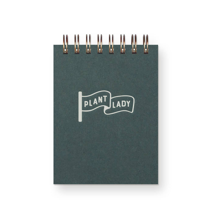 Dark green cover with a "plant lady" flag in the center. Sturdy wire-o binding.