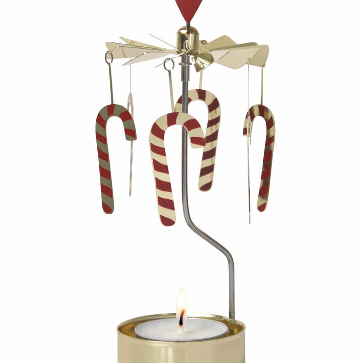 Tea light in a gold holder with vertical arm supporting a carousel of six red-striped candy canes.