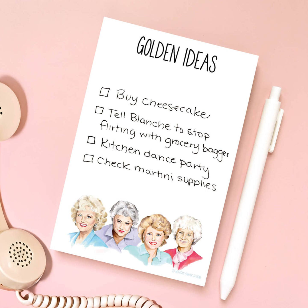 Notes written on the page between the title "Golden Ideas" and the illustration of the four women in the television show, next to a pen on the right and telephone handset on the left.