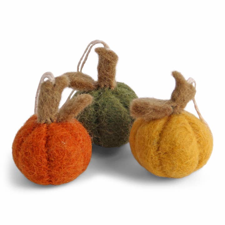 Three small felted pumpkins in orange, green, and yellow, with brown stem and attached string for hanging.