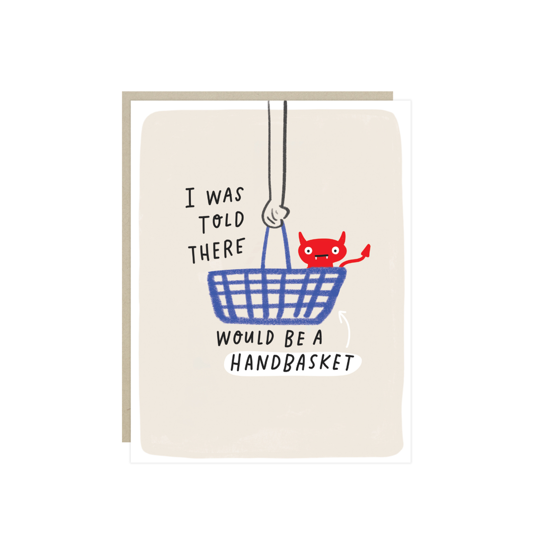 Red devil in a blue basket being held by arm and hand with the text 'I was told there would be a Handbasket' in hand drawn lettering.