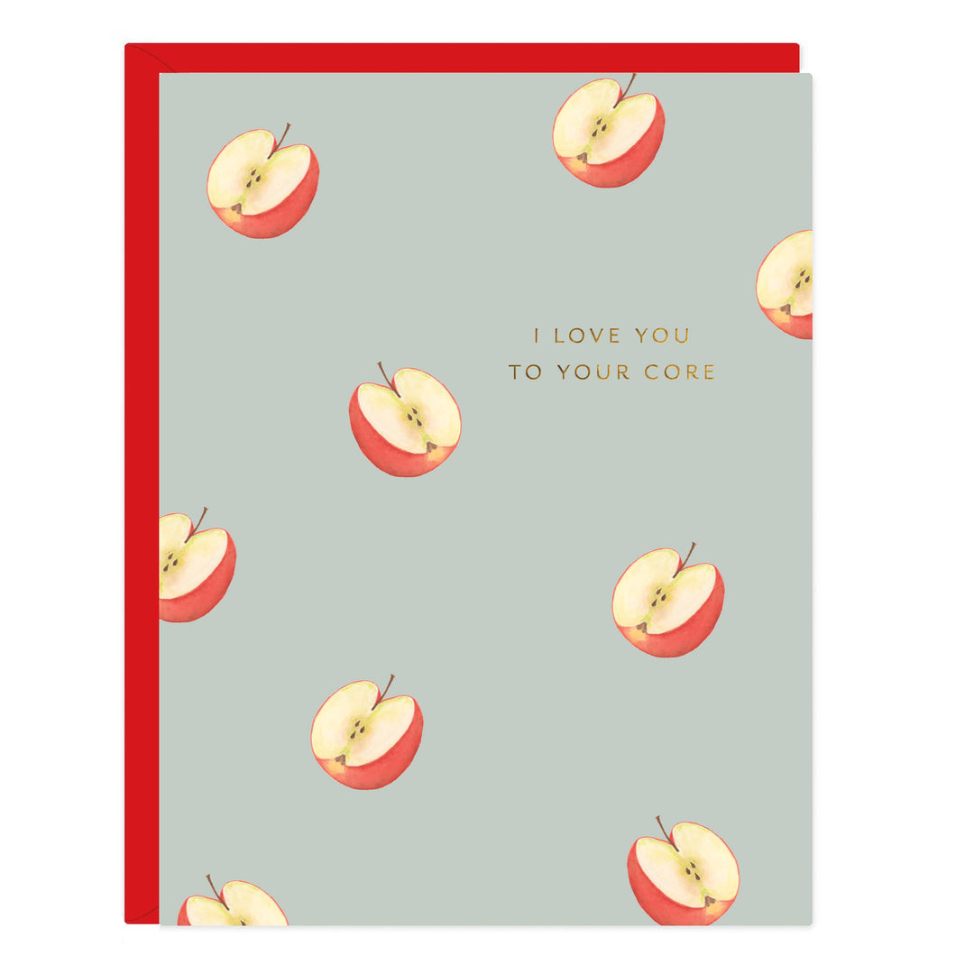 Card with a pattern of cut open apples and 'I love you to your core' text on a light blue background with red envelope.