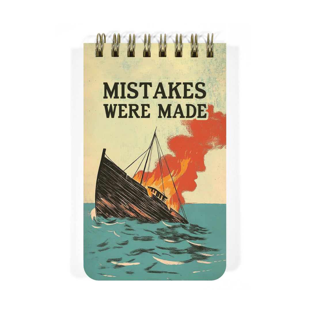 Spiral notepad with a burning sinking boat  design on the cover, featuring the text 'Mistakes Were Made'.