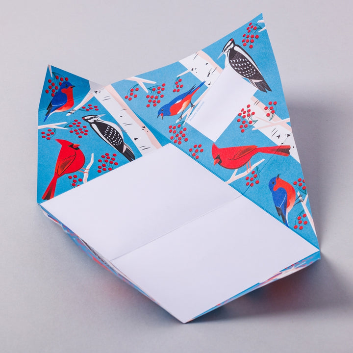 Pigeon letter unfolded to show white writing area and birds.