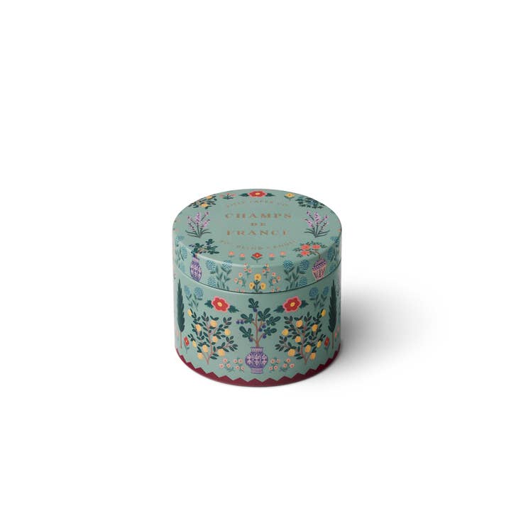 Round tine with loral design on a sage green background.