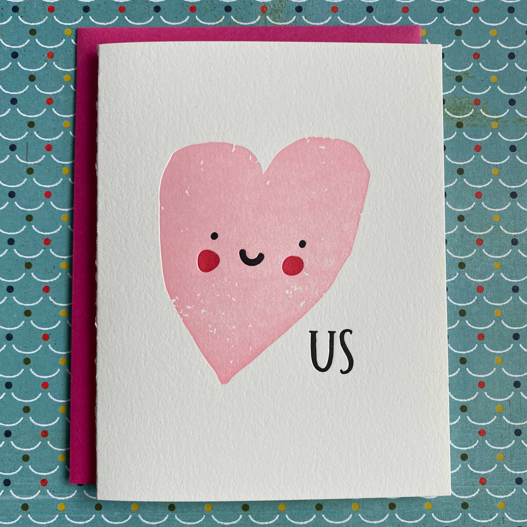 Big pink heart with simple face and black text below on white cardstock