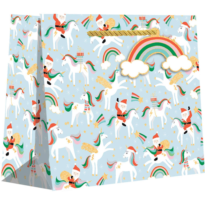 Gift bag with unicorns and rainbows on a light blue background. Santa is riding some of the unicorns.