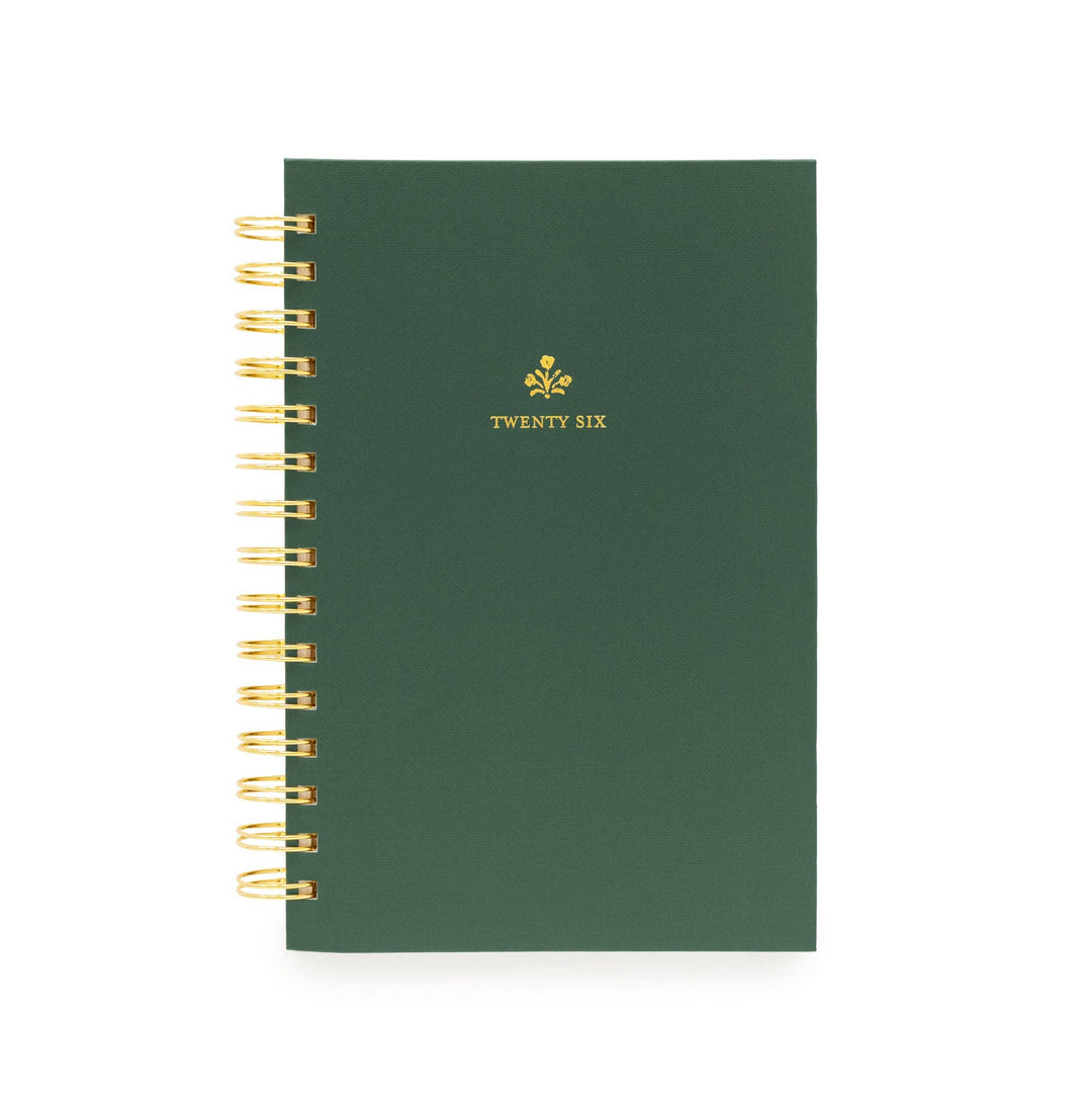 Green cover of planner, with gold spiral binding on the left, and "twenty six" printed in gold.