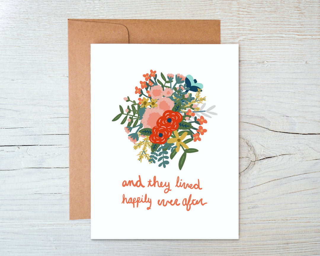 Greeting in lowercase orange script under a bouquet of primarily orange, pink and yellow flowers.