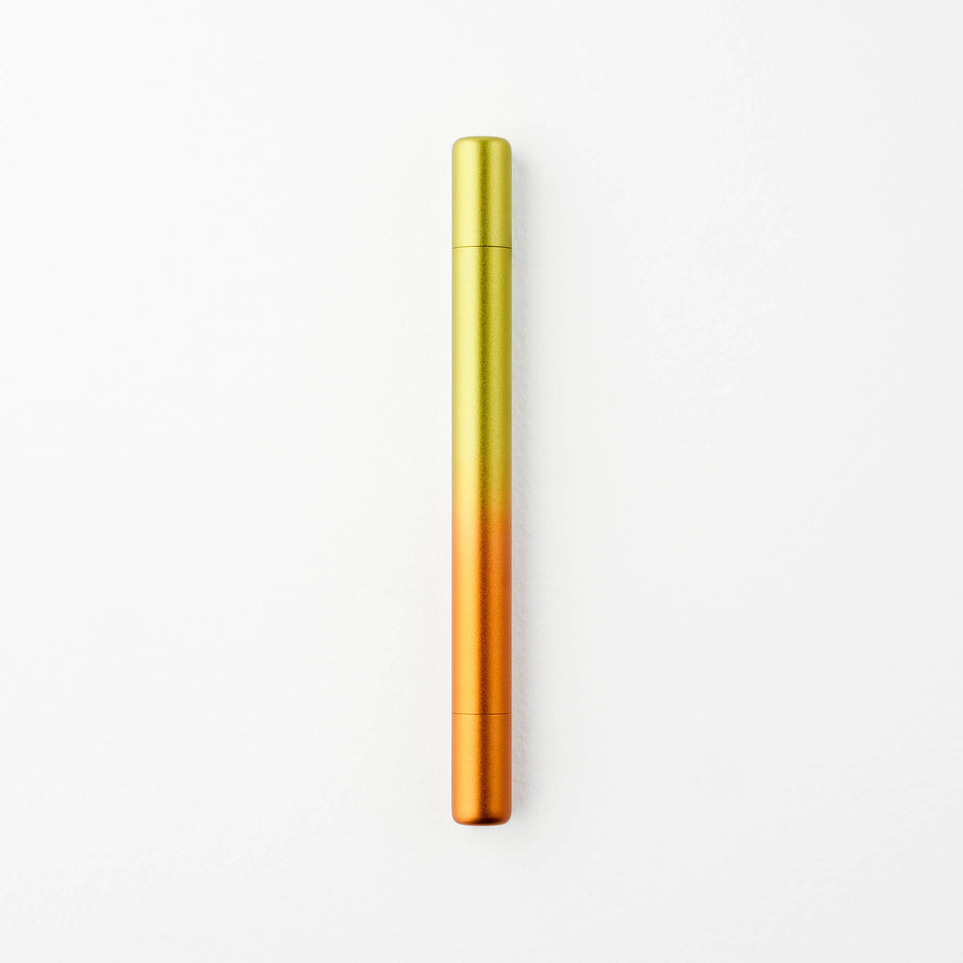 Gradient yellow to orange pen with caps on either end.