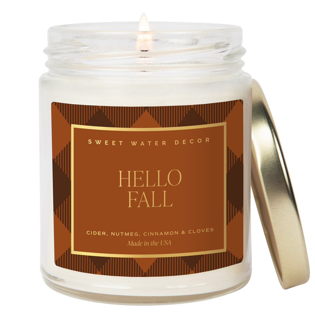 Lighted candle in opaque jar with 'Hello Fall' label 