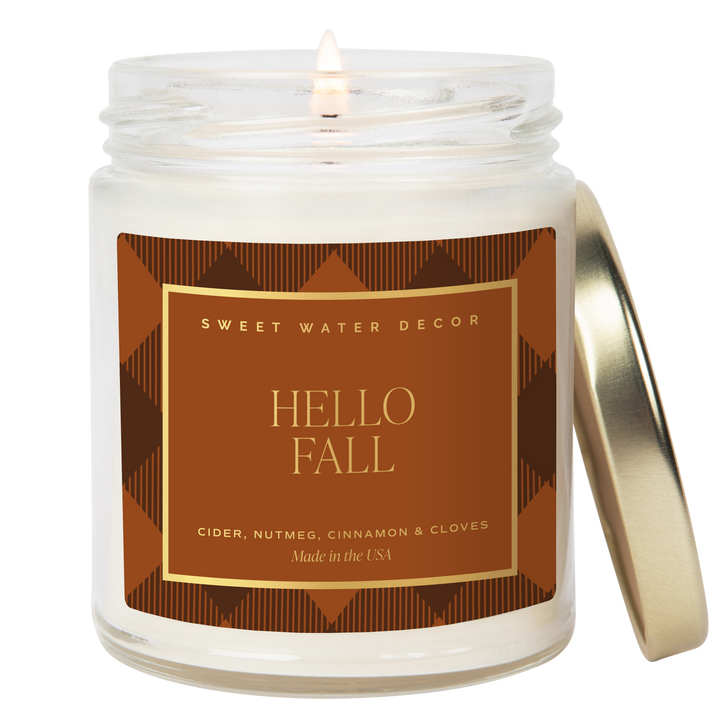 Lighted candle in opaque jar with 'Hello Fall' label 