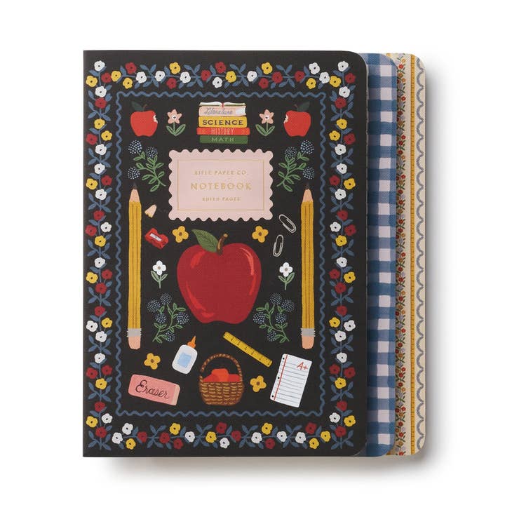 Three notebooks in the set stacked one atop another.