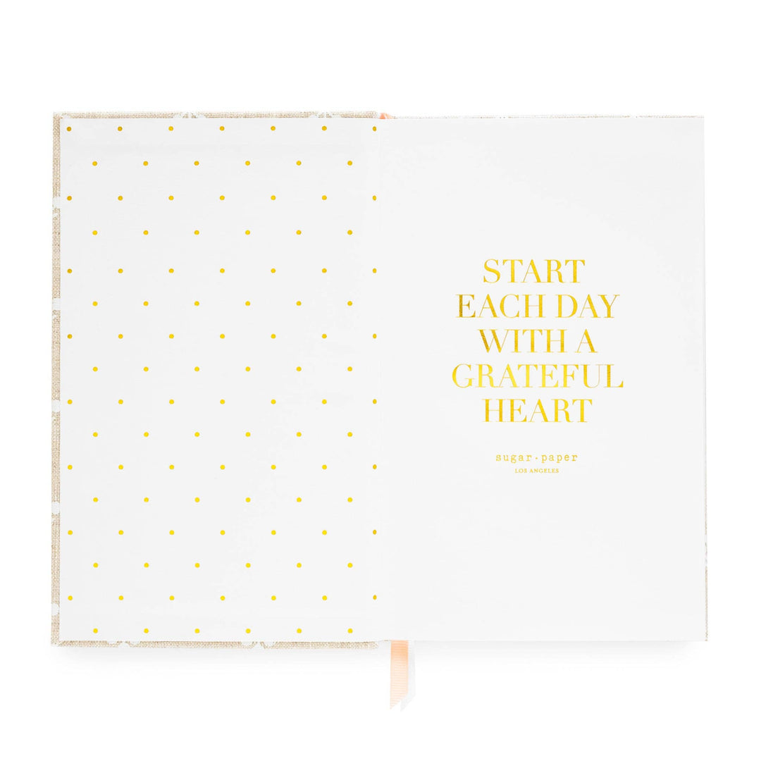 Inside cover of notebook, with dots on the left side and an inspirational quote on the right, 'Start each day with a grateful hear.'