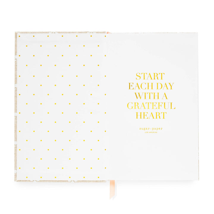 Inside cover of notebook, with dots on the left side and an inspirational quote on the right, 'Start each day with a grateful hear.'