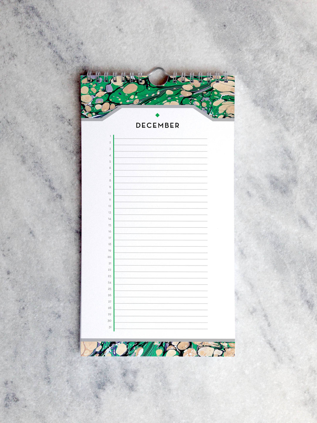Page for December with marbled paper in shades of green and beige at the top and bottom. Below the month title is a line for each day of the month.