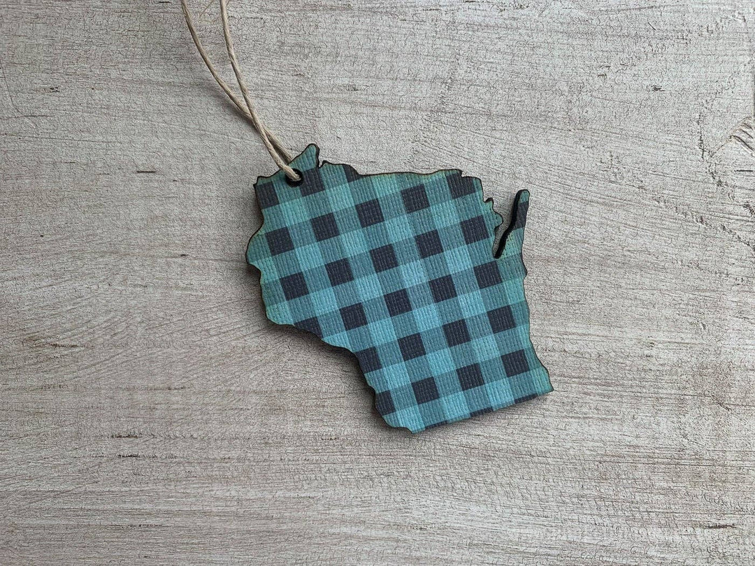 Ornament cut in the shape of the state of Wisconsin in blue buffalo plaid and a hanging string.