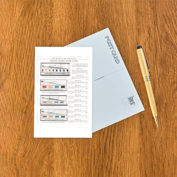 Front and back of postcard next to a pen.