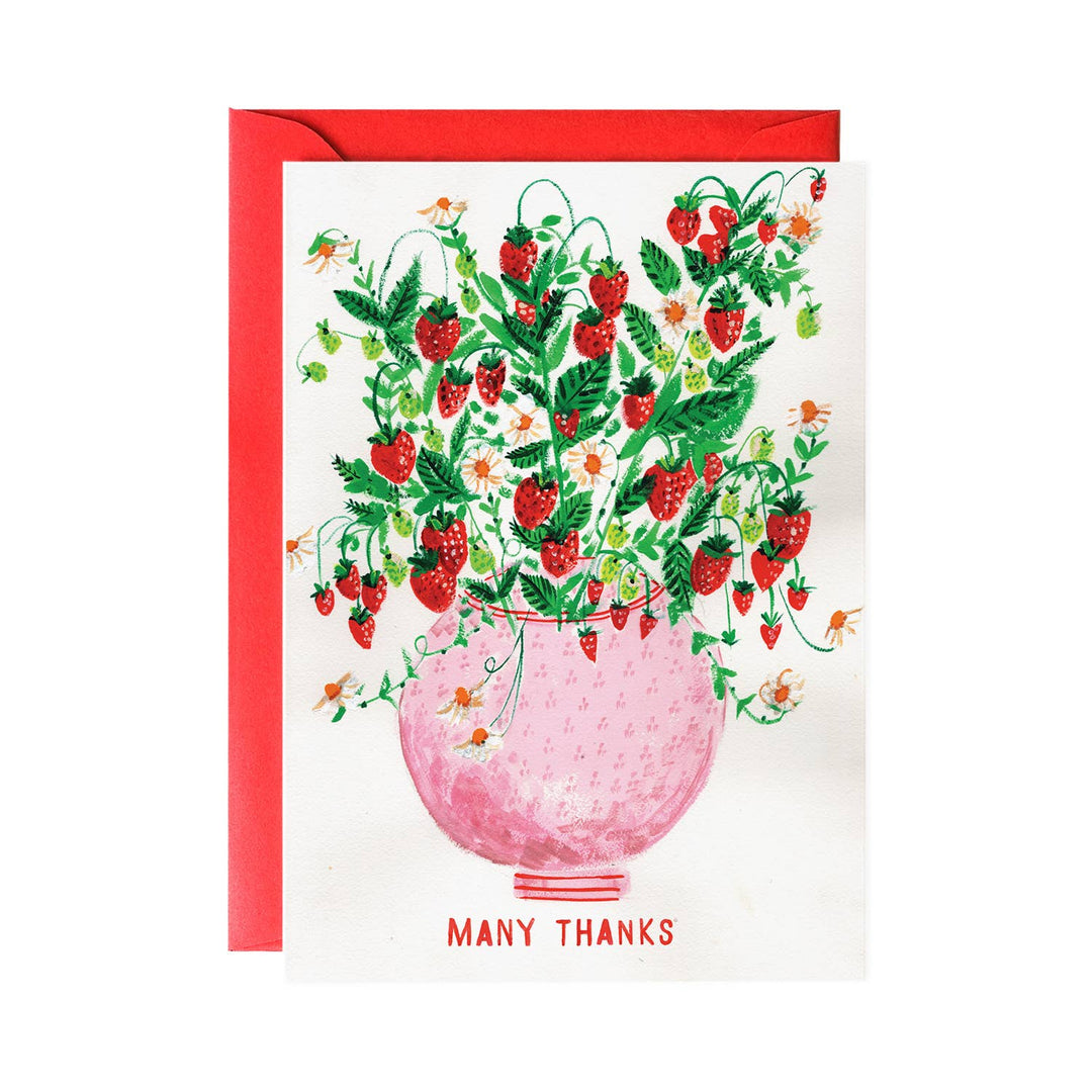 A round pink vase overflowing with strawberries. Text at bottom in red.