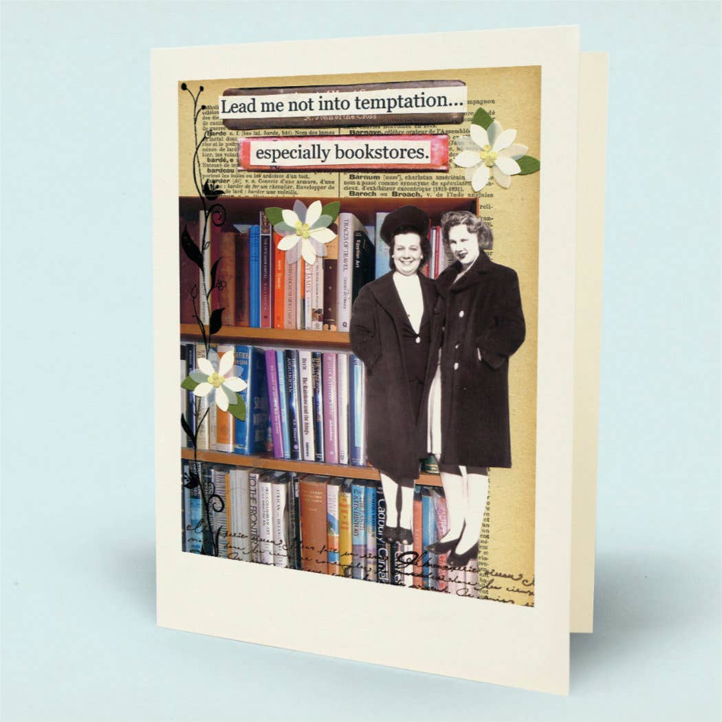 A greeting card with a cream border, featuring a collage design of bookshelves, books, white flowers, and two women in dark coats. The top text reads, 'Lead me not into temptation... especially bookstores.'