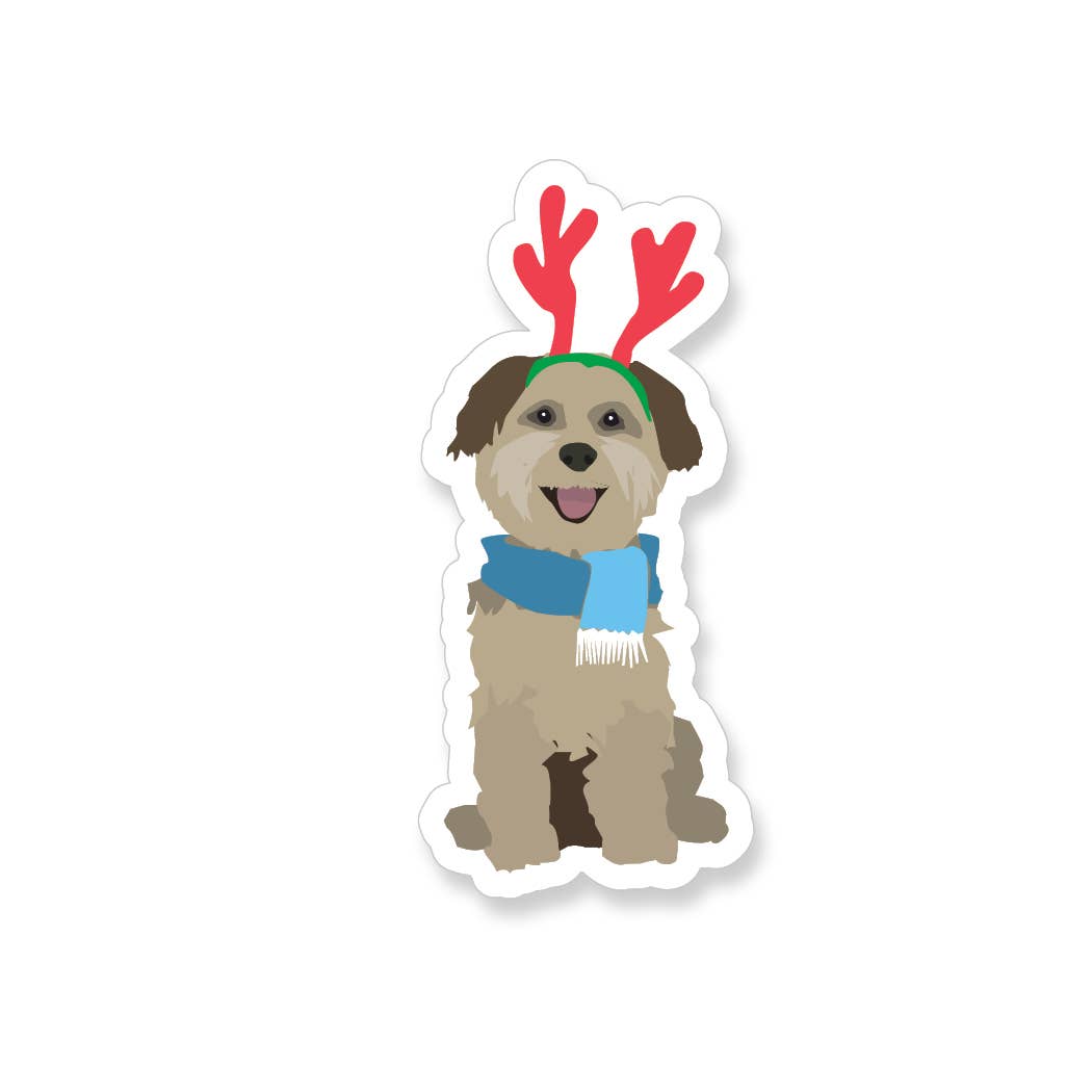 Happy brown puppy wearing red reindeer antlers and a blue scarf.