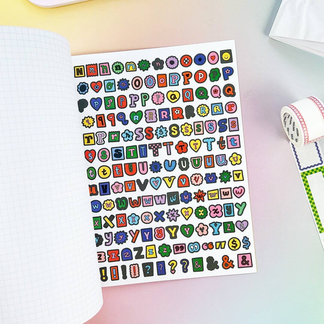 Sample page from sticker book with decorative letters and symbols.