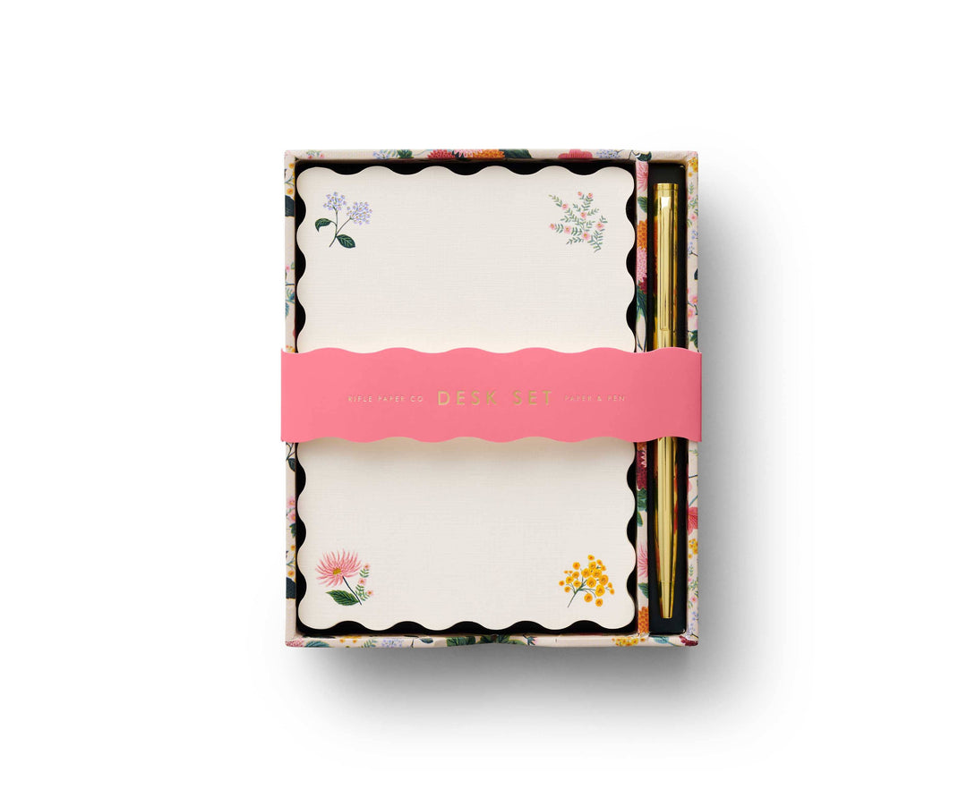 Stationery with scalloped edge and floral designs in the corners, in a decorative box with a space to store the gold pen.