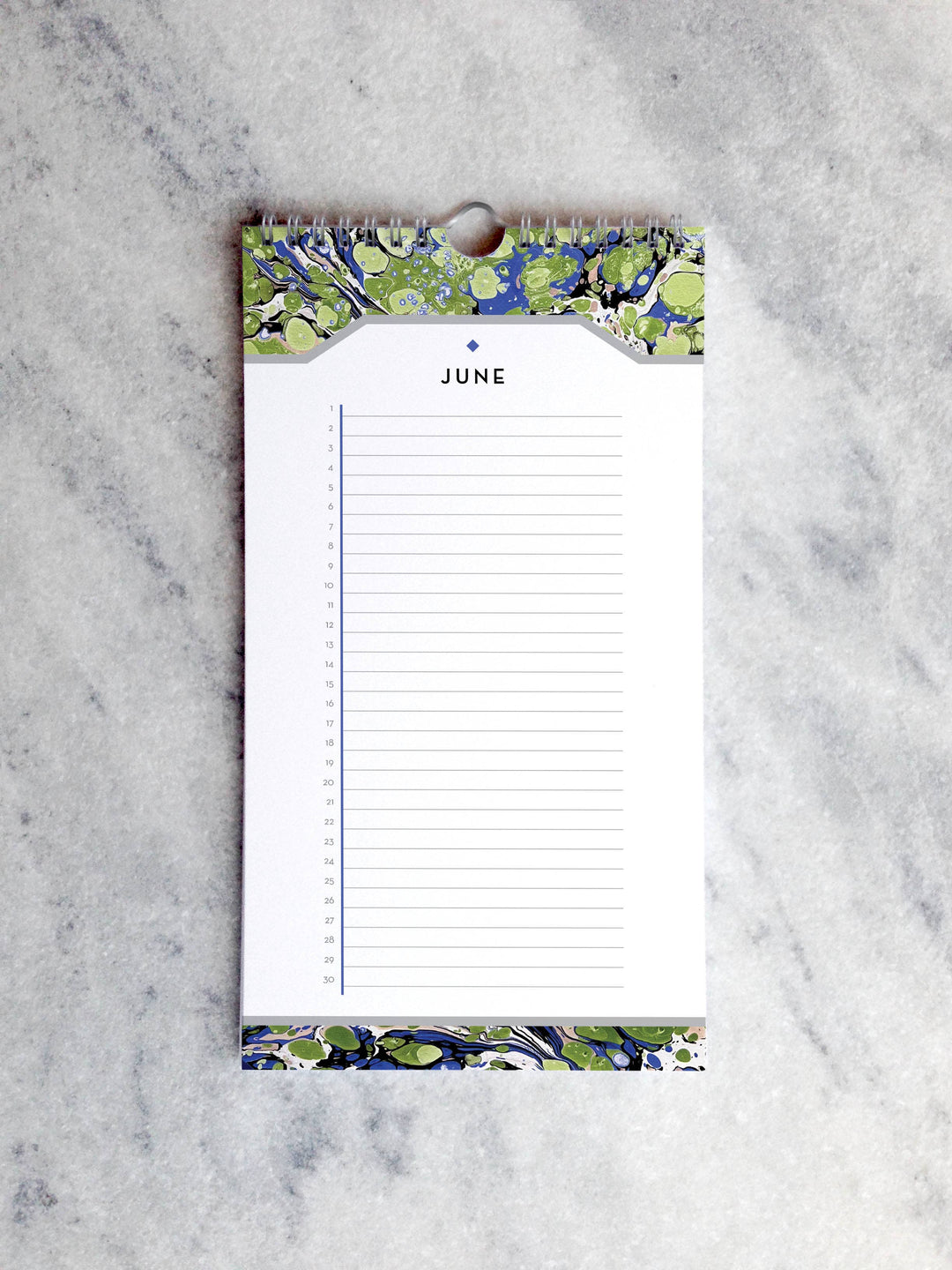 Page for June  with marbled paper in shades of green and purple at the top and bottom. Below the month title is a line for each day of the month.