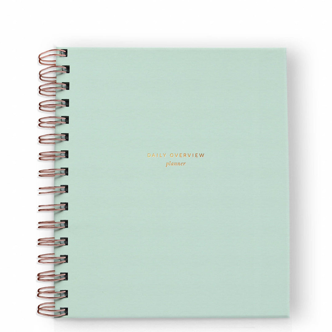 Cover of daily planner in mint with gold spiral binding on the left side.