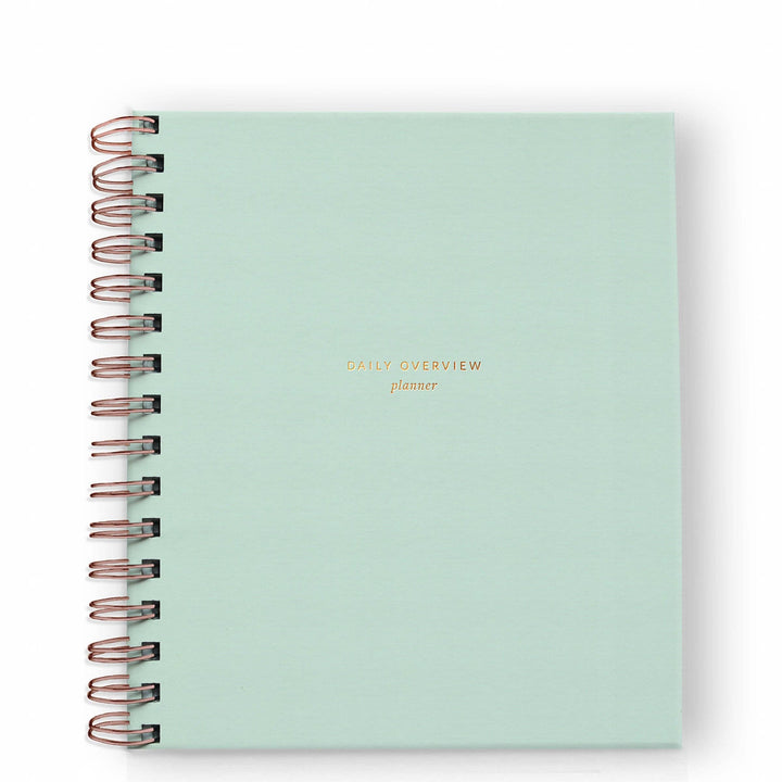 Cover of daily planner in mint with gold spiral binding on the left side.
