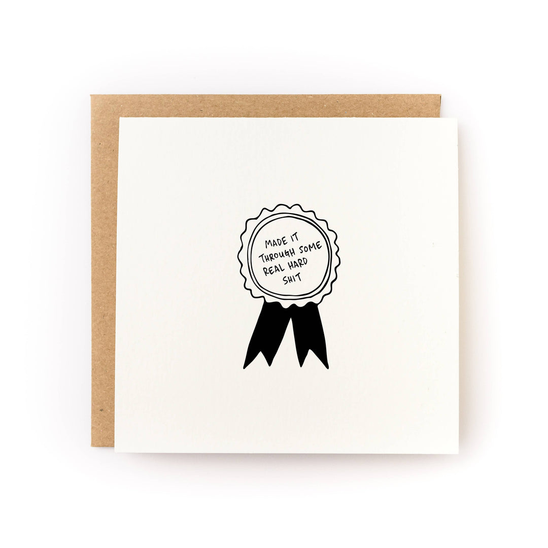 Card with drawing of a ribbon award with the text "Made it through some real hard shit."