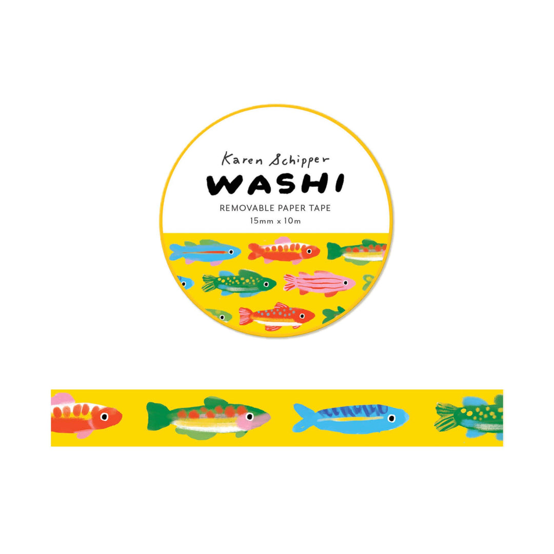 A roll of Karen Schipper Washi removable paper tape featuring a colorful fish pattern on a bright yellow background, with a sample strip shown below the circular package label.