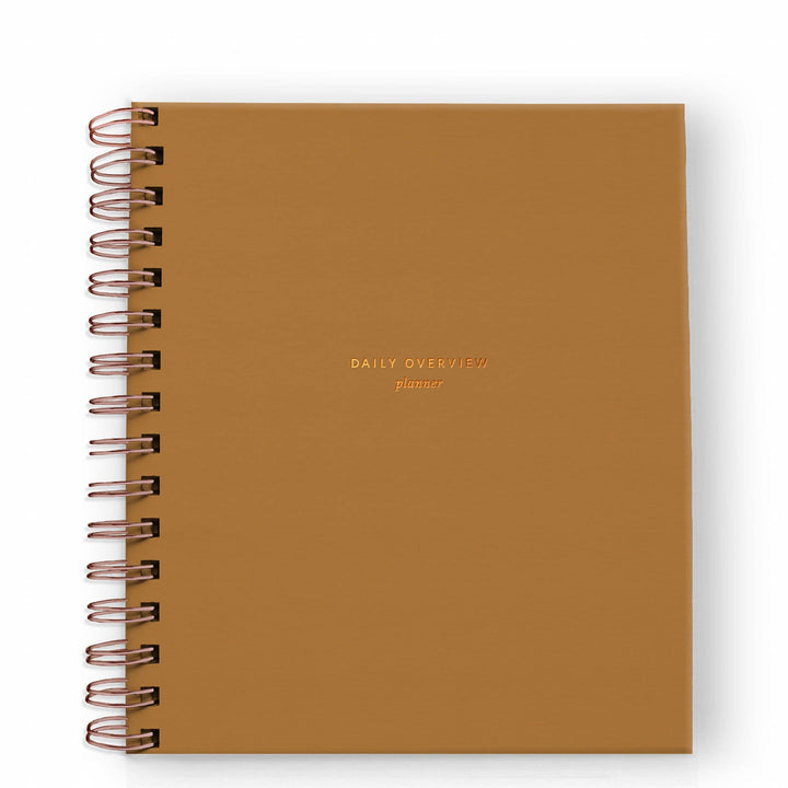 Cover of daily planner in mustard with gold spiral binding on the left side.