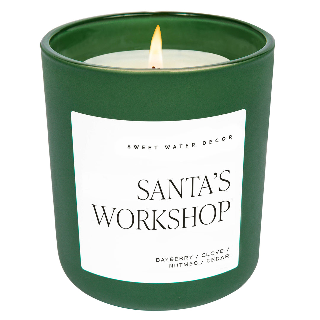 Scented soy candle in green matte container. Label is Santa's Workshop bayberry / clove / nutmeg / cedar