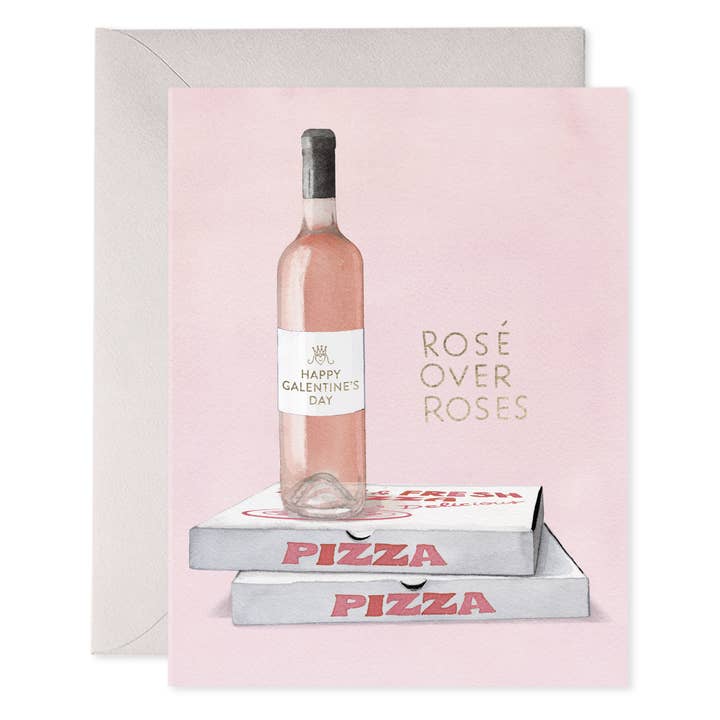 Front of card with a bottle of rosé wine with a label "Happy Galentine's Day" placed atop two pizza boxes and the text "Rosé over roses."