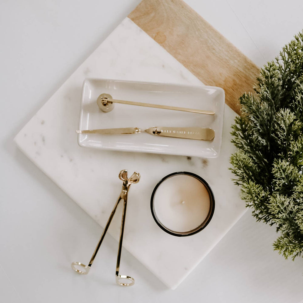 Candle kit in brass plate on a tray.