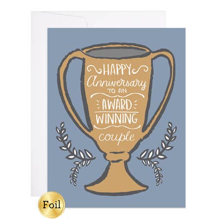 Large gold loving cup with white text and wreath surrounding it on blue cardstock