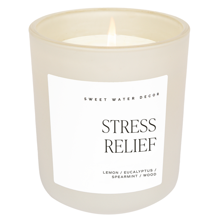 Scented soy candle in matte white glass container. Label is Stress Relief  Lemon / Eucalyptus / Spearmint / Wood