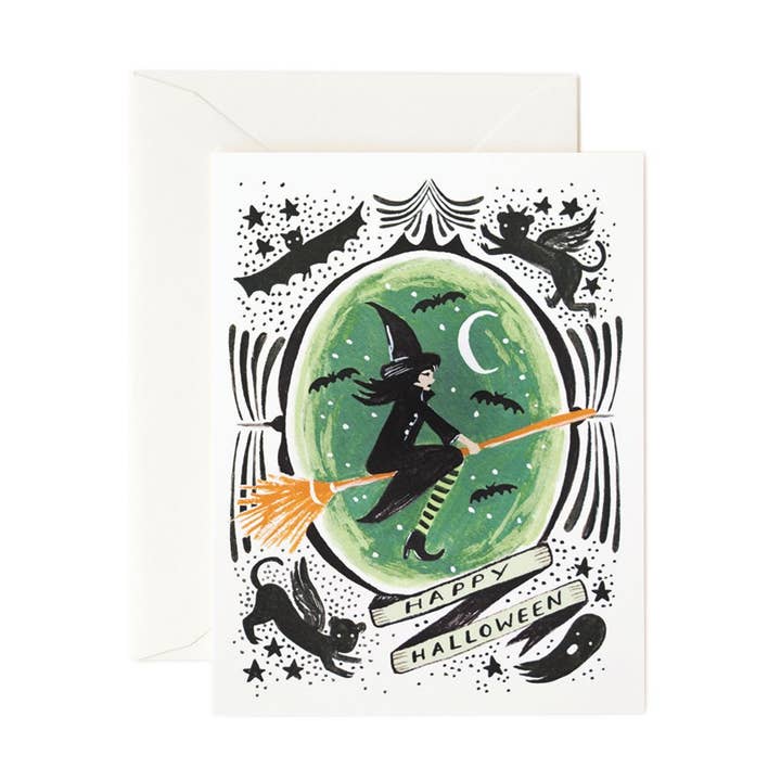 Front of card with a witch on a broom on a green background surrounded by black bats, cats, and ghosts
