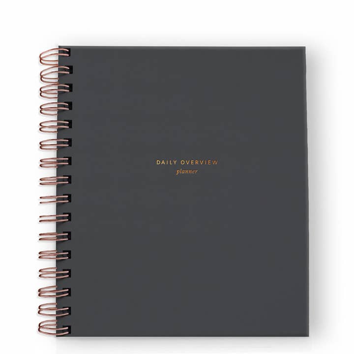 Cover of daily planner in charcoal with gold spiral binding on the left side.