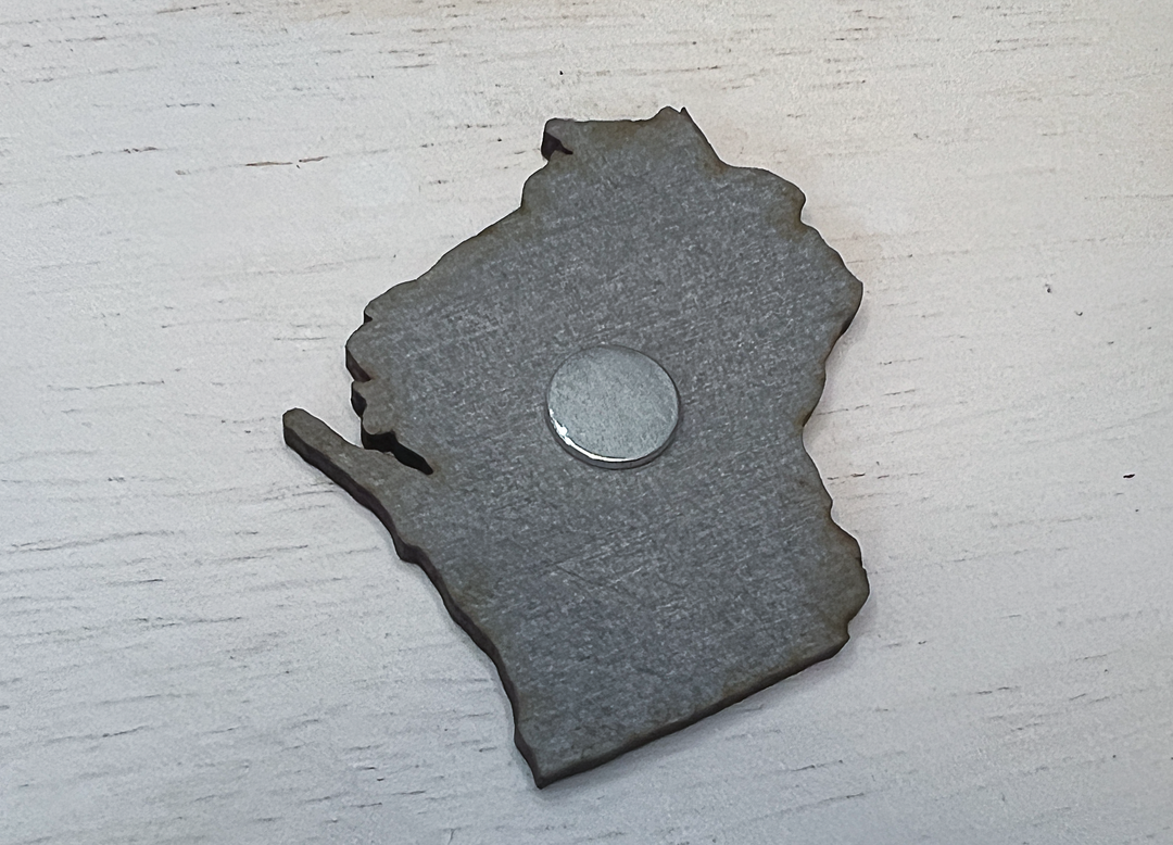 Back of the magnet with round magnet on gray wood.