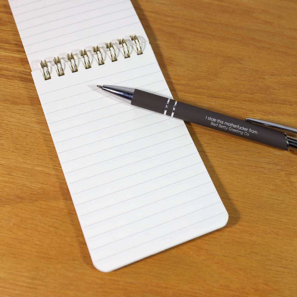 Open notebook with lined pages and a pen.
