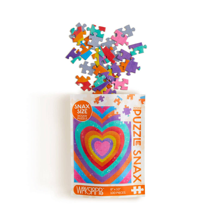 Colorful puzzle pieces spilling into a bag labeled 'Puzzle Snax' with a heart design..