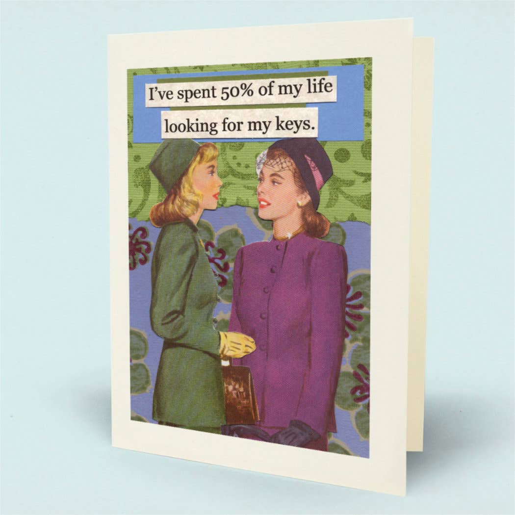 A greeting card with a white border, featuring a vintage-style illustration of two women in colorful clothing and a blue banner with the text, 'I've spent 50% of my life looking for my keys.' 