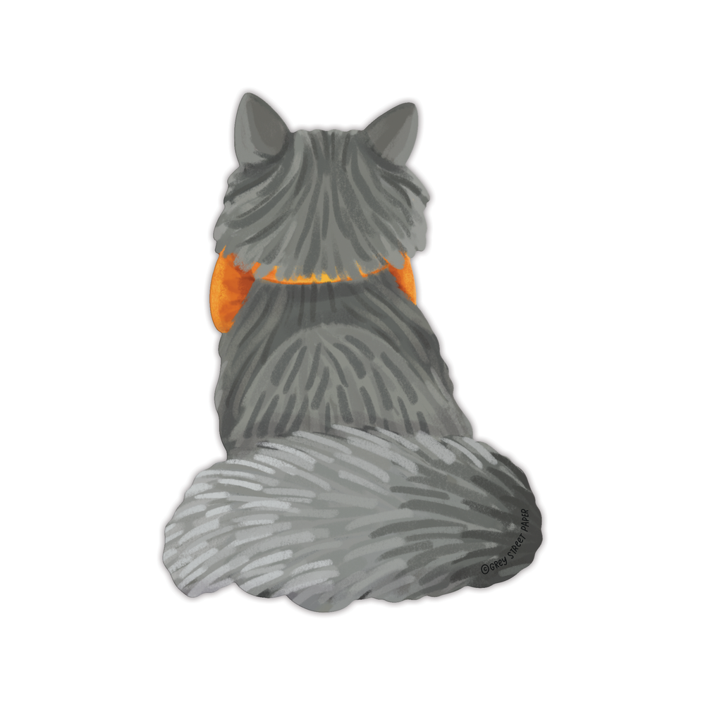 Back of bookmark of the cat from behind, with the orange bow peaking out of either side of the cat's neck.