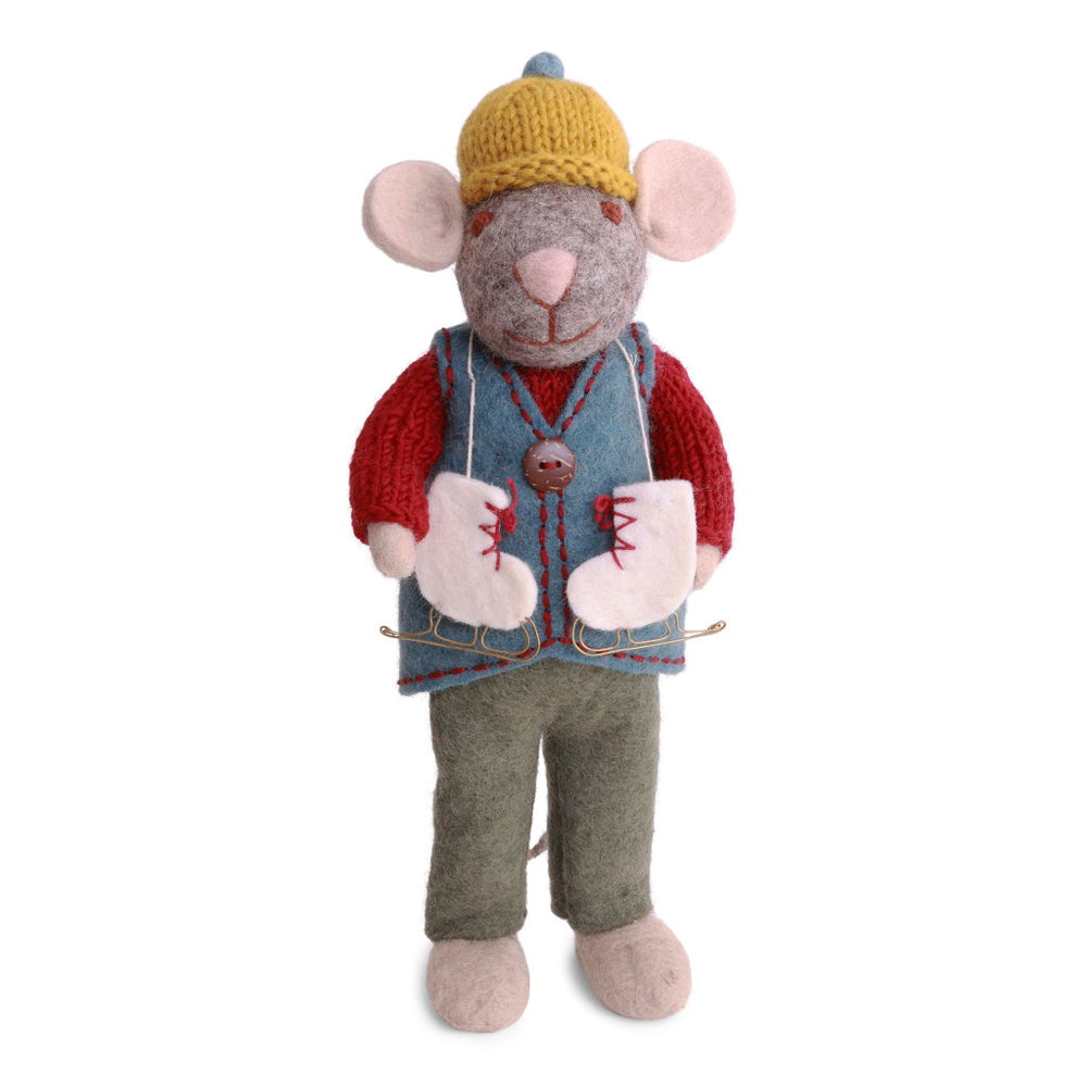 A felted wool mouse dressed in a yellow knit hat, red sweater, blue vest, and green pants, with a pair of white ice skates with red laces draped around his neck.