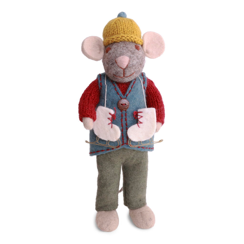 A felted wool mouse dressed in a yellow knit hat, red sweater, blue vest, and green pants, with a pair of white ice skates with red laces draped around his neck.