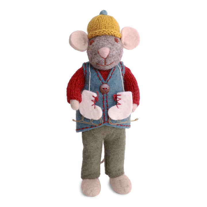 A felted wool mouse dressed in a yellow knit hat, red sweater, blue vest, and green pants, with a pair of white ice skates with red laces draped around his neck.
