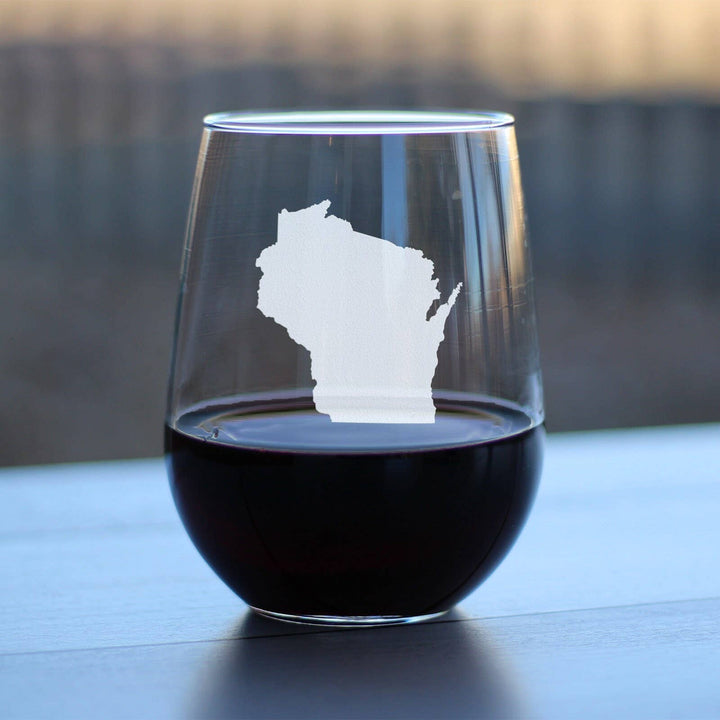 Stemless wine glass with the silhouette of Wisconsin etched on it and containing red wine.