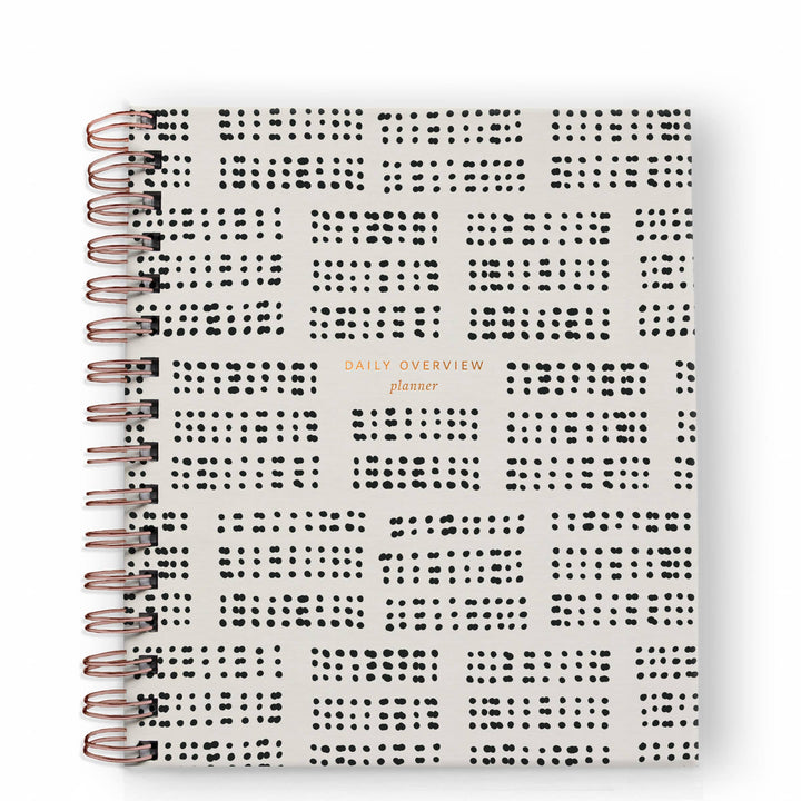 Cover of planner with a pattern of domino-like black circles.